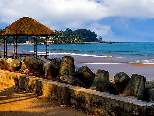 Thatched gazebo and sea wall at Chivla Beach, Malvan